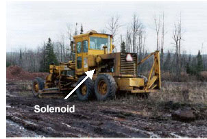 Photo of the grader with arrow pointing to solenoid