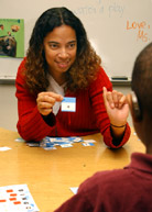Image of a woman practicing Finger Spelling with a boy