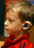 Image of a boy wearing a hearing aid