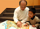 Image of a father and son looking at a map