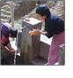 Link to Environmental Health (Photo of two woman getting water from a well)