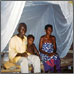 Link to Infectious Diseases (Photo of a family sitting under bednet)
