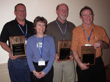 Photograph: Greg S. Bevenger, Albert Todd, Michael Furniss pose with their awards and Anne Zimmermann, Director of WFW USFS