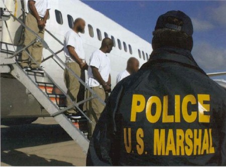 Picture of prisoners being escorted from aircraft