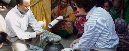 Drs. Rita Colwell and Anwar Huq demonstrating use of sari to filter water for cholera in Bangladesh