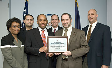 NRC staff hold a certificate signifying the approved license renewal for the Shearon Harris nuclear power plant in North Carolina. The plant is now authorized to continue operation through 2046.