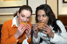 Image of two teen girls eating hamburgers