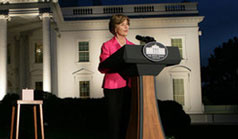 Photo of Mrs. Laura Bush preparing to push the button, Oct. 7, 2008, to light up the White House in a pink glow as part of Breast Cancer Awareness. Preventing and curing breast cancer is a cause that Mrs. Bush has worked toward around the world.