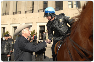 Newly confirmed Secretary of the Interior Ken Salazar is greeted by a mounted U.S. Park Policeman at the entrance of Interior Headquarters.
