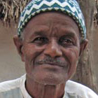 A Pulaar villager with sample of kosam, a key component of the region's diet.