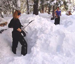 Snow survey students begin to build their snow cave.