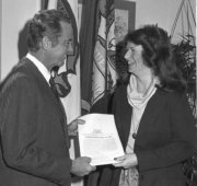 Governor Bill Milliken, presents then-State Representative Stabenow with a copy of Michigan's landmark domestic violence law, which she authored.