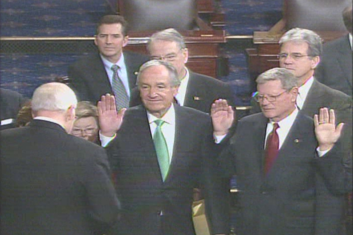 Picture of Senator Harkin holding up his right hand while being sworn in