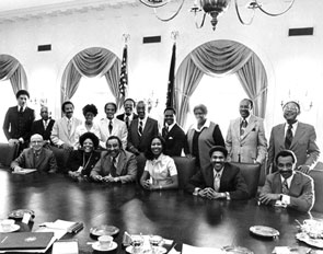 After an August 1974 meeting with President Gerald R. Ford, the CBC posed for a picture. Standing from left to right are: <a href="/member-profiles/profile.html?intID=38">Ronald Dellums</a> of California, <a href="/member-profiles/profile.html?intID=32">Robert Nix, Sr.</a>, of Pennsylvania, <a href="/member-profiles/profile.html?intID=89">John Conyers, Jr.</a>, of Michigan, <a href="/member-profiles/profile.html?intID=24">Shirley Chisholm</a> of New York, <a href="/member-profiles/profile.html?intID=48">Andrew Young, Jr.</a>, of Georgia, Assistant to the President Stan Scott, <a href="/member-profiles/profile.html?intID=62">Ralph Metcalfe</a> of Illinois, <a href="/member-profiles/profile.html?intID=78">Walter Fauntroy</a> of the District of Columbia, <a href="/member-profiles/profile.html?intID=67">Barbara Jordan</a> of Texas, <a href="/member-profiles/profile.html?intID=34">Louis Stokes</a> of Ohio, <a href="/member-profiles/profile.html?intID=29">Charles Diggs, Jr.</a>, of Michigan. Seated left to right are: <a href="/member-profiles/profile.html?intID=30">Gus Hawkins</a> of California, <a href="/member-profiles/profile.html?intID=40">Cardiss Collins</a> of Illinois, <a href="/member-profiles/profile.html?intID=110">Charles Rangel</a> of New York, <a href="/member-profiles/profile.html?intID=123">Yvonne Brathwaite Burke</a> of California, <a href="/member-profiles/profile.html?intID=25">Bill Clay, Sr.</a>, of Missouri, and <a href="/member-profiles/profile.html?intID=60">Parren Mitchell</a> of Maryland.