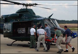 Team of FBI medics transport a Bureau employee in need of medical attention during an operational deployment.