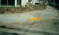 Case Study: Photo of a parallel curb ramp with detectable warnings in a narrow sidewalk.