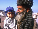 An older man holding a young child in Pakistan