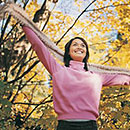 Breast cancer survivor in pink sweater outdoors