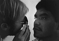 An image of a Pima man getting his eyes examined.