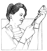 Health care provider, wearing gloves, drawing medicine into a syringe.