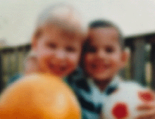 A very blurry photo of two boys, illustrating vision with a cataract.