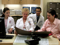 Cardiology staff discussing  a patient's improvement 