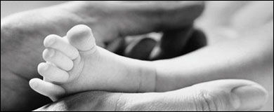 Photo: A hand holding a tiny foot
