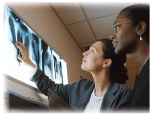 Photo of two people looking at X-ray films