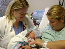 A medical student at The University of Texas Health Science Center at San Antonio celebrates new life with a mother and baby while on obstetrics rotation at the Regional Academic Health Center, a campus of the Health Science Center in the Lower Rio Grande Valley of Texas