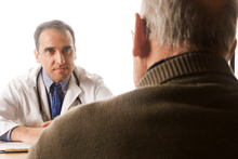 A photo of an older man consulting with his doctor.