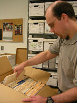 Person packing records into a box