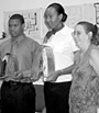 Howard University students Omar Clennon and Suzannah Codlin receive their design awards while NIH's Kristy Long looks on.