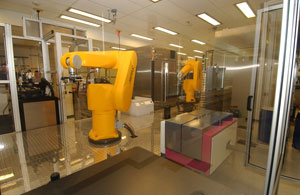Housed at the NIH Chemical Genomics Center, these Kalypsys robots perform precision plate handling for high throughput screening.