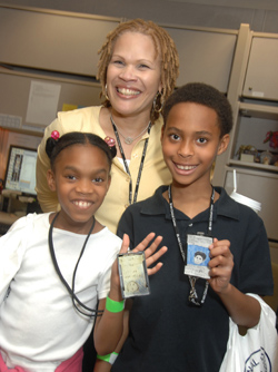 Bria Jones and Drew Lewis display the badges they made before coming to NIH for the day.