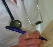 Photo of a doctor or nurse writing in a chart