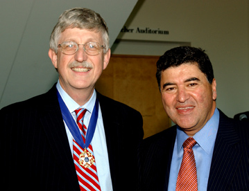 Dr. Francis Collins (l) shows his new medal, joined by NIH director Dr. Elias Zerhouni.