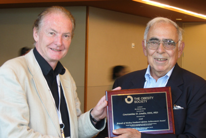 Dr. Constantine Londos (r) received the Obesity Society’s Stunkard Lifetime Achievement Award from Dr. Eric Ravussin Oct. 4 at the society’s annual meeting in Phoenix. Londos was recognized for his many contributions to adipocyte research. The award recognizes outstanding contributions to the field of obesity through scholarship, mentorship and education. Recipients receive a $1,000 cash prize and present the plenary Friends of Mickey Stunkard Award Lecture.