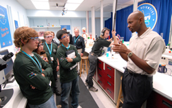 Dr. Milton English (r) of NHGRI discusses zebrafish with Discovery Challenge “disease detectives.”