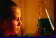 Female student observing liquid in beaker