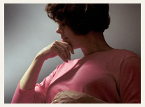 Silhouette of pensive-looking woman with short, dark hair.