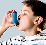 Boy using asthma inhaler image