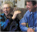 Mary Lavigne, age 102, shares a laugh in her home with Thomas Perls, M.D., founder and director of the New England Centenarian Study. Ms. Lavigne has lived in three centuries. Perls and his colleagues are studying centenarians and their siblings for signs of longevity genes and other genetic traits.