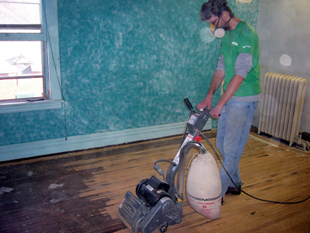 man sanding floors