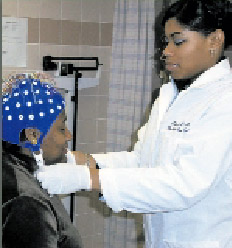 image of Howard Univ. Collaborative Alcohol Research staff demonstrate how an EEG cap is applied