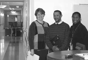 Beverly Barham, R.N., B.S.N., nurse specialist (l), and Mildred Wilson, R.N., nurse specialist (r), join Dr. Dennis at one of the three spacious nurses' stations in the NIAMS new space on the fifth floor.