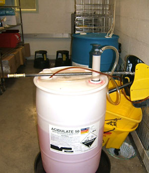 Tunnel and rack washers are periodically manually de-scaled with phosphoric acid, as shown here. Phosphate-free cleaners are more friendly to Chesapeake Bay.