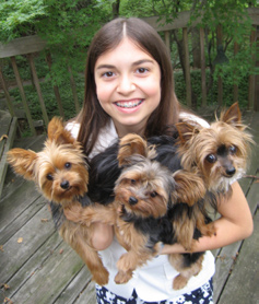 Kelsey Curd Ladt holding three puppies