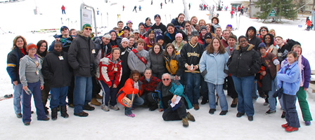 Fifty-three teen and young adult patients who are being treated for cancer at local hospitals recently enjoyed a learn-to-ski weekend at Bryce Resort, in Basye, Va. The trip was sponsored by R&W and its Ski Club, in collaboration with Special Love/Camp Fantastic. Shown with the kids slopeside is R&W President Randy Schools (seated, c).
