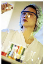 Picture of female researcher looking at a slide in a laboratory.