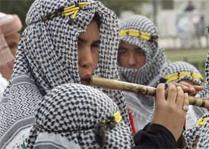 A musician wearing traditional headdress performs at welcoming ceremony, Algiers, Algeria, March 21, 2005. [&#169; AP Images]